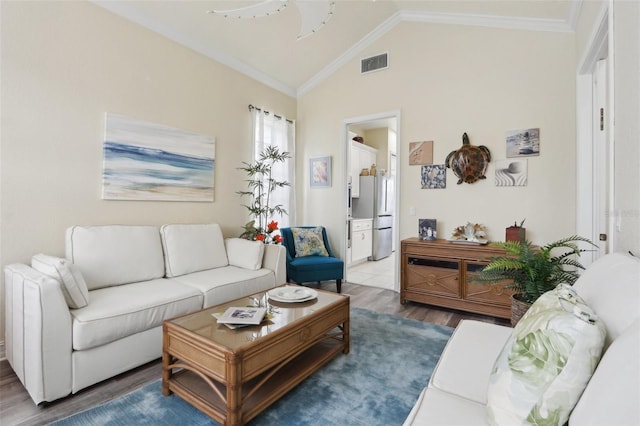 living room featuring lofted ceiling, hardwood / wood-style floors, and ornamental molding