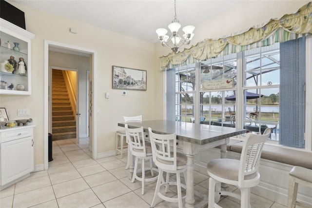 tiled dining room featuring a notable chandelier