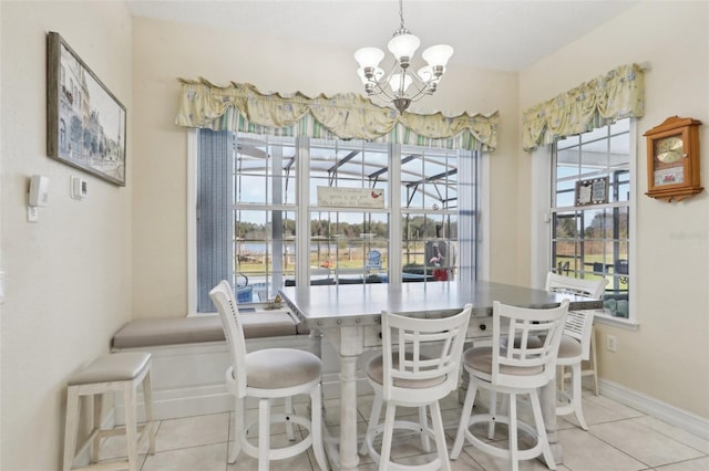 dining area with light tile patterned floors and a notable chandelier