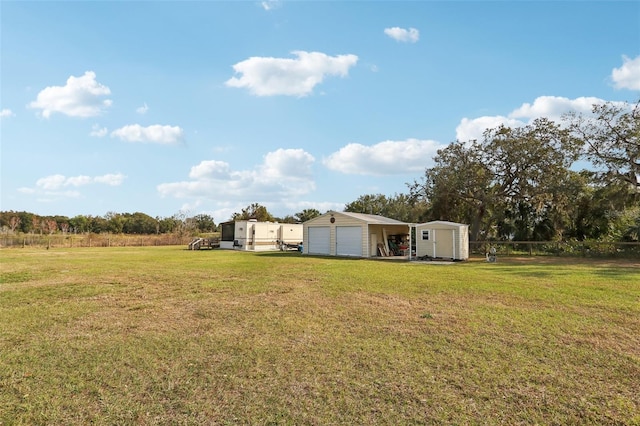 view of yard with a garage and a storage unit