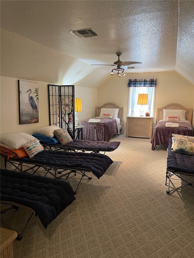 carpeted bedroom featuring ceiling fan, vaulted ceiling, and a textured ceiling