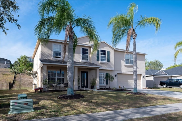 view of front of house featuring a garage, a front lawn, and a porch