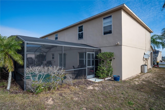 rear view of property with a lanai