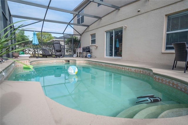 view of swimming pool with a patio area, a lanai, and grilling area