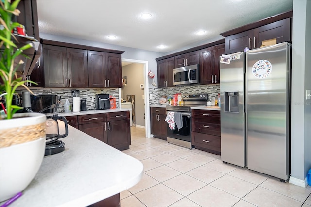 kitchen with light tile patterned floors, backsplash, appliances with stainless steel finishes, and dark brown cabinetry