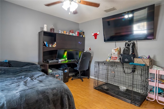 bedroom with ceiling fan and wood-type flooring