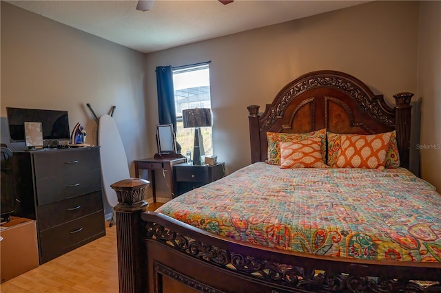 bedroom with ceiling fan and wood-type flooring