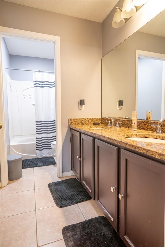 full bathroom featuring shower / bath combo with shower curtain, toilet, vanity, and tile patterned flooring