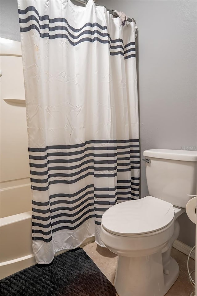 bathroom with toilet and shower / bath combination with curtain