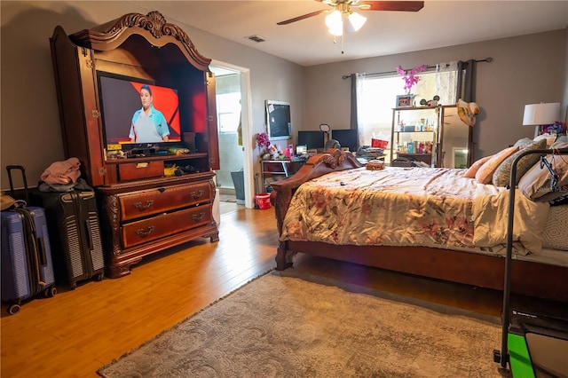 bedroom with ceiling fan and light hardwood / wood-style flooring