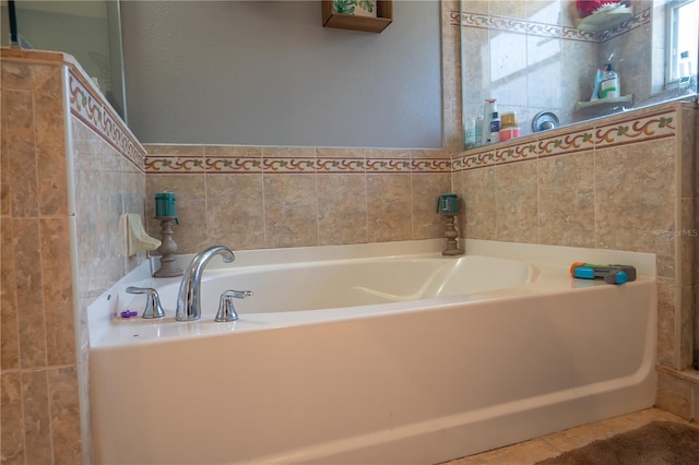 bathroom with a bathing tub and tile patterned floors