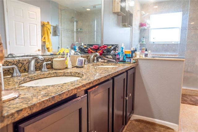 bathroom featuring a tile shower and vanity