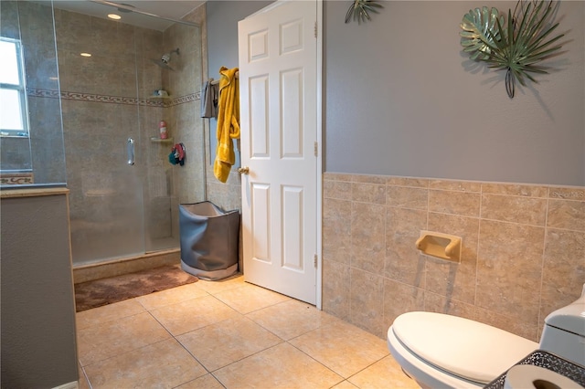 bathroom with an enclosed shower, tile walls, tile patterned floors, and toilet