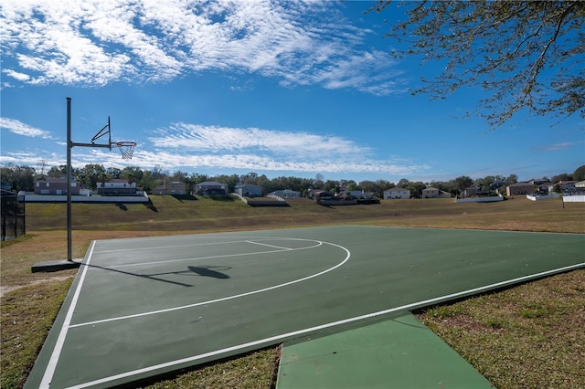 view of sport court with a yard