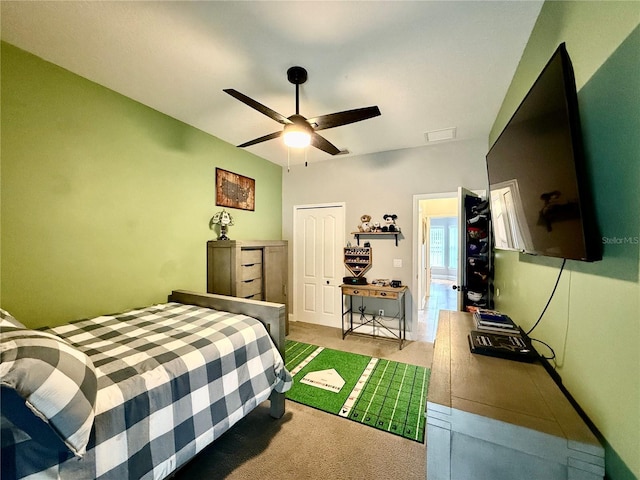 carpeted bedroom featuring a closet and ceiling fan