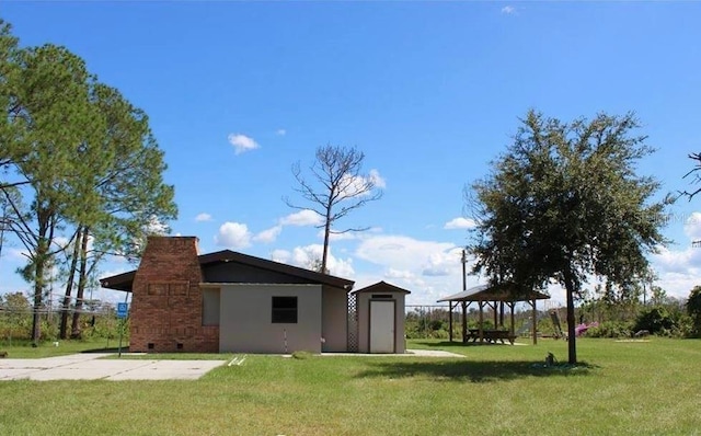 exterior space with a gazebo and a storage unit