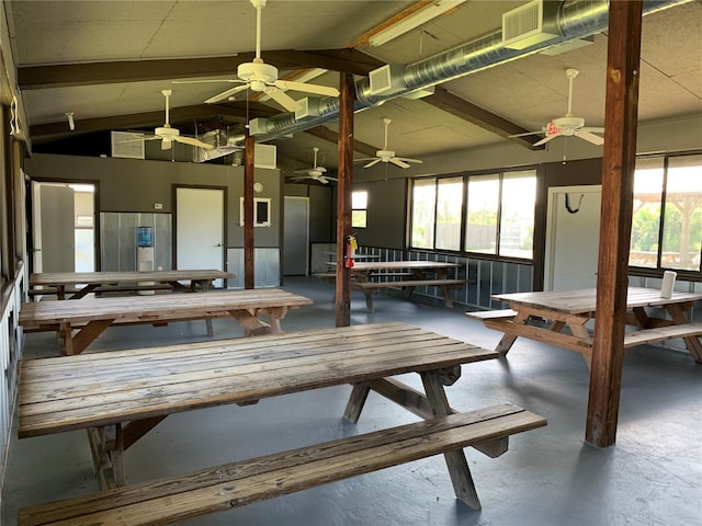 interior space with lofted ceiling with beams and concrete floors