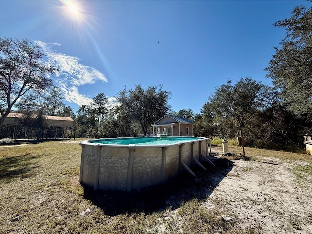 view of pool featuring a lawn