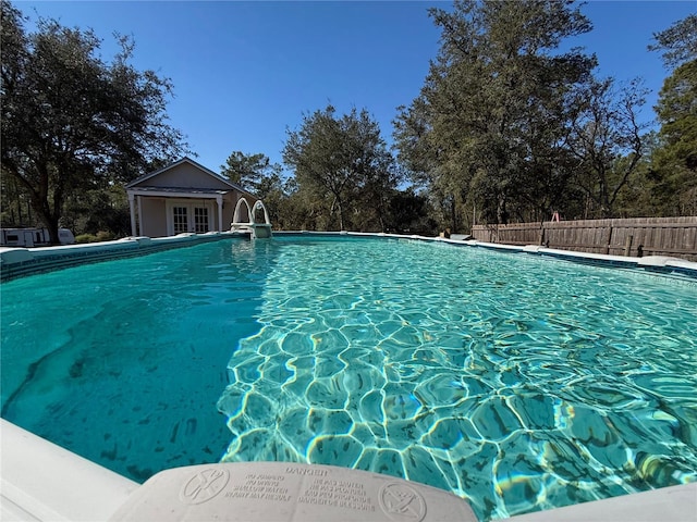 view of pool featuring french doors