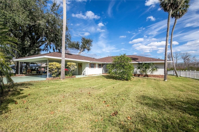 back of house featuring a yard and a carport