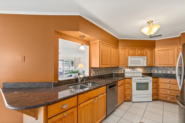 kitchen with light tile patterned flooring, pendant lighting, sink, kitchen peninsula, and stainless steel appliances