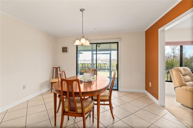 dining space with light tile patterned flooring, crown molding, and a chandelier