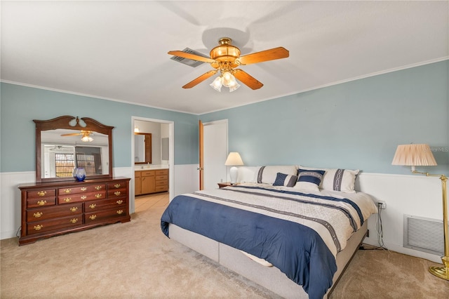 bedroom featuring ornamental molding, ceiling fan, and ensuite bathroom