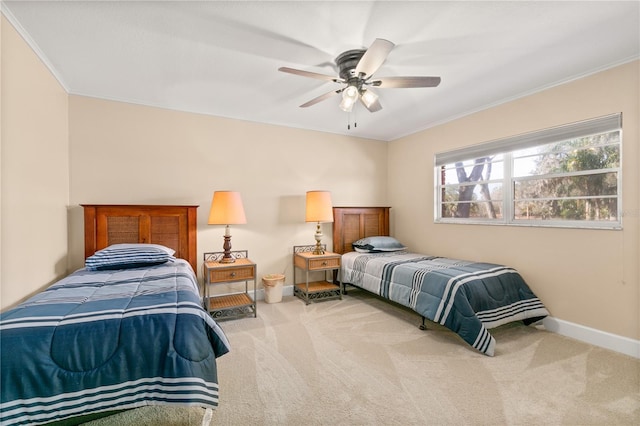 bedroom with light carpet, ornamental molding, and ceiling fan