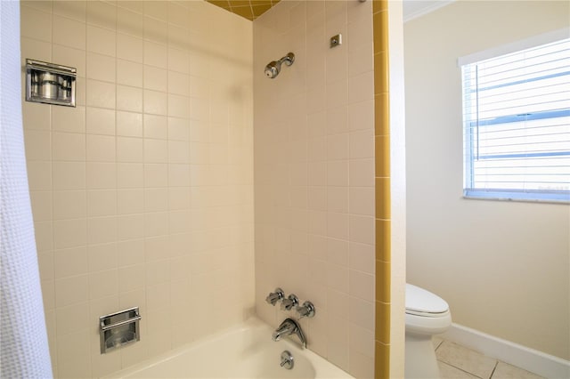 bathroom with tile patterned flooring, a wealth of natural light, shower / tub combo with curtain, and toilet