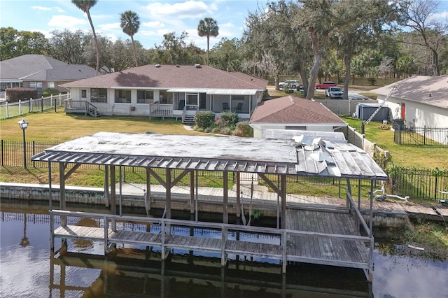 view of dock with a water view and a yard