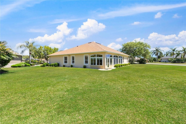 rear view of house with a lawn