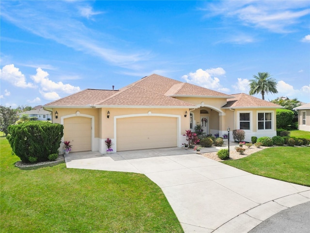 mediterranean / spanish home with a garage and a front yard