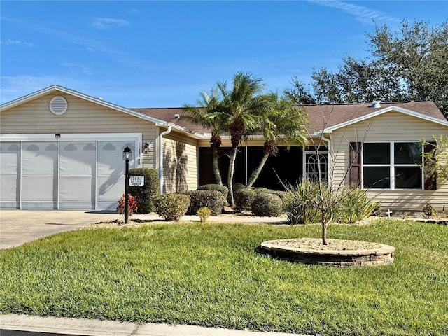 ranch-style home with a front lawn and a garage