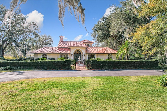 mediterranean / spanish home featuring a front yard