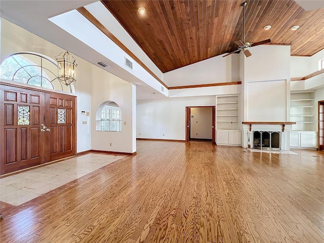 entryway with wood ceiling, high vaulted ceiling, light hardwood / wood-style flooring, and a wealth of natural light