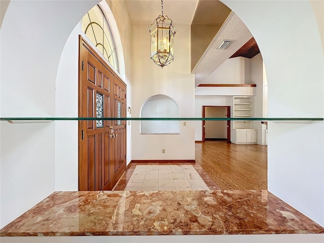 foyer with a notable chandelier and light hardwood / wood-style floors