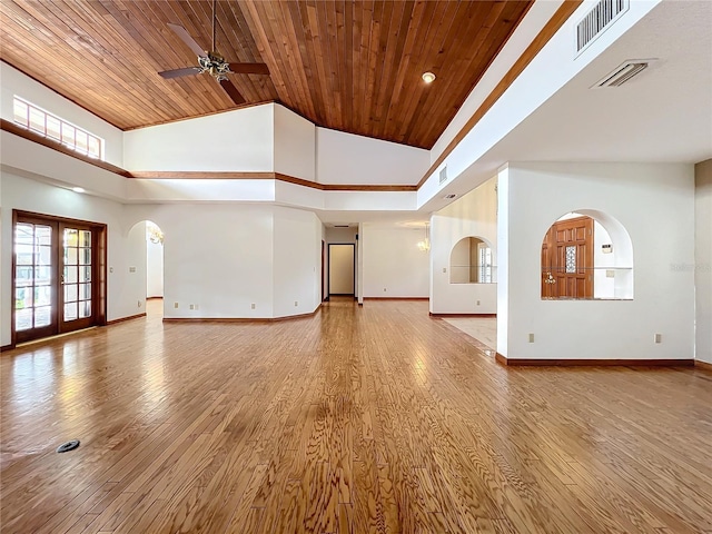 unfurnished living room featuring wood ceiling, light hardwood / wood-style flooring, and a high ceiling