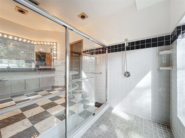 bathroom with tile patterned flooring and walk in shower