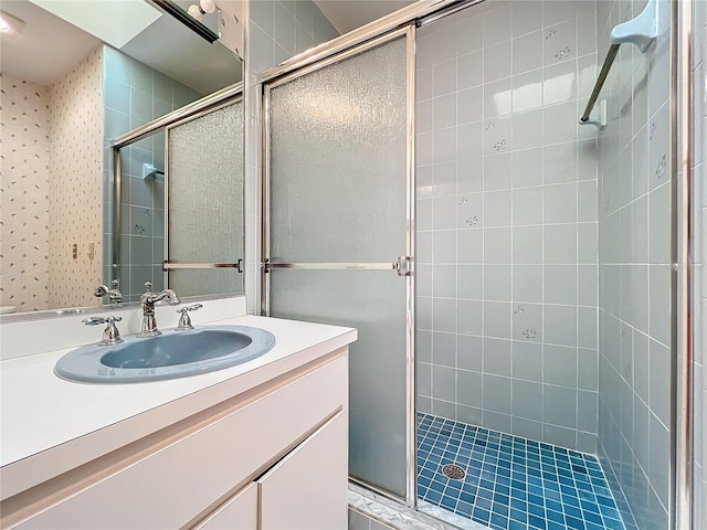 bathroom with walk in shower and vanity