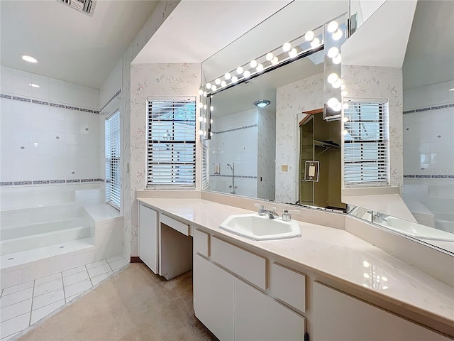 bathroom featuring independent shower and bath, vanity, and tile patterned floors