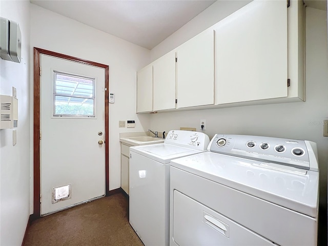 laundry area with cabinets, sink, and washing machine and dryer