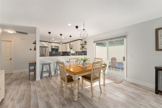 dining area featuring light wood-type flooring