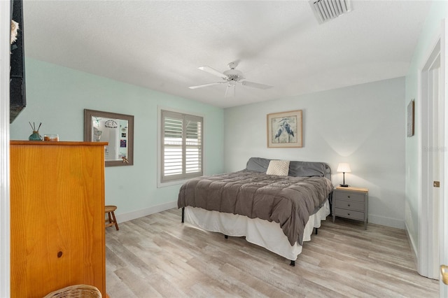 bedroom with ceiling fan and light hardwood / wood-style flooring