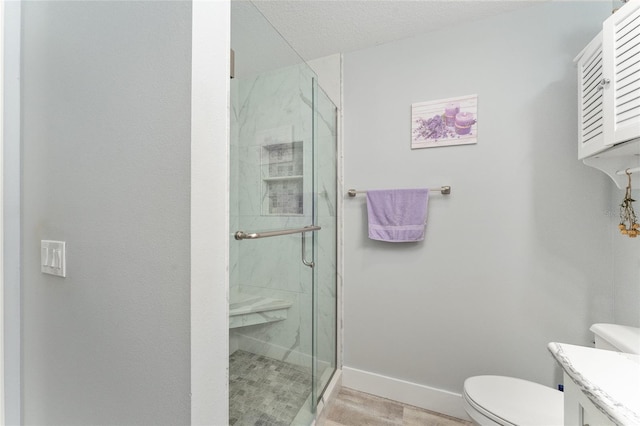 bathroom featuring walk in shower, vanity, and toilet