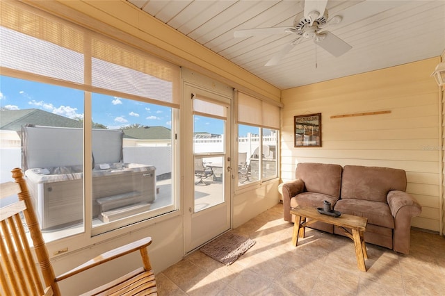 sunroom / solarium featuring wood ceiling and ceiling fan