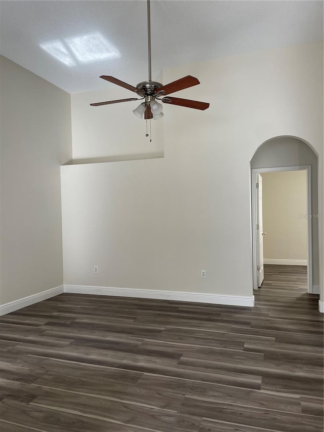 spare room featuring a textured ceiling, ceiling fan, lofted ceiling, and dark hardwood / wood-style floors