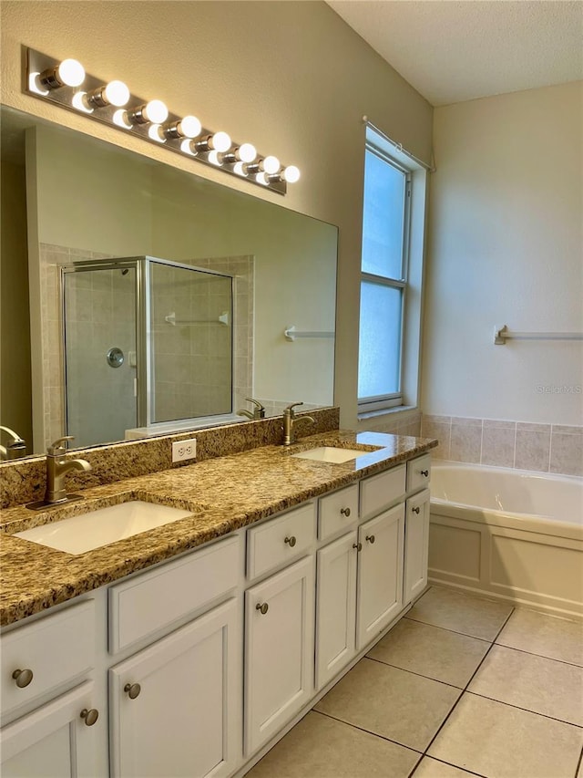 bathroom featuring vanity, independent shower and bath, and tile patterned flooring