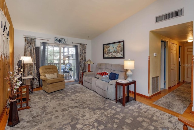 living room featuring lofted ceiling