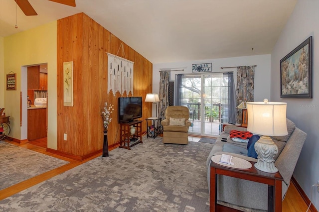 living room with wood walls and vaulted ceiling