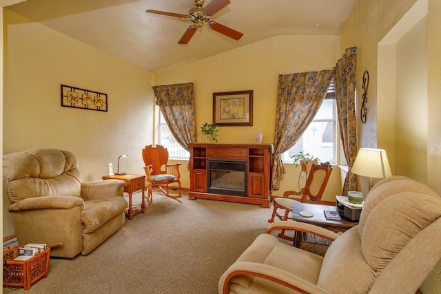 sitting room with ceiling fan, light carpet, and vaulted ceiling